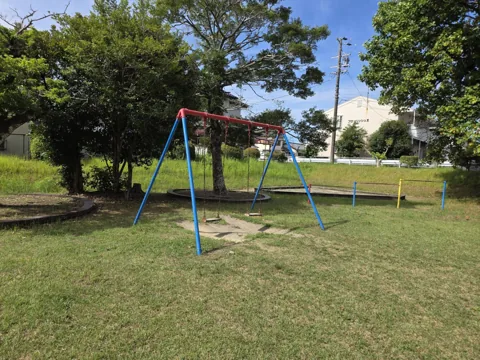 的場公園：ブランコと砂場、奥に鉄棒。芝生の広場