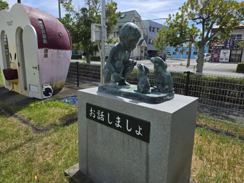 北川瀬公園：子どもの像「お話しましょ」。左奥にトイレ